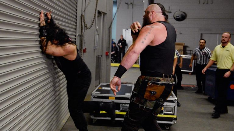 Braun Strowman started the attack by slamming Roman Reigns into wall.
