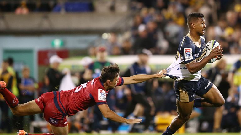  Aidan Toua of the Brumbies evades a tackle to score a try against the Reds