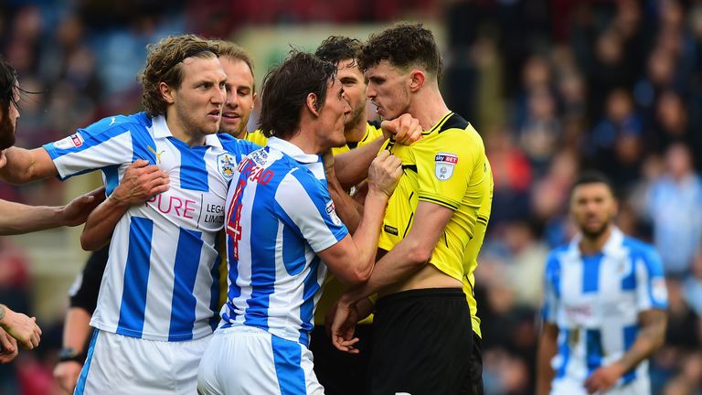 Dean Whitehead of Huddersfield Town confronts Tom Flanagan of Burton Albion during the Sky Bet Championship match