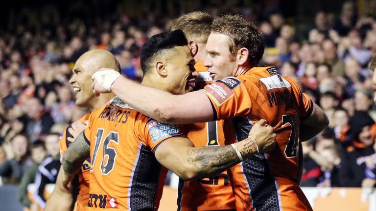 Castleford Tigers' Joel Monaghan (right) celebrates scoring a try with team-mates as the home side crushed Huddersfield 52-16