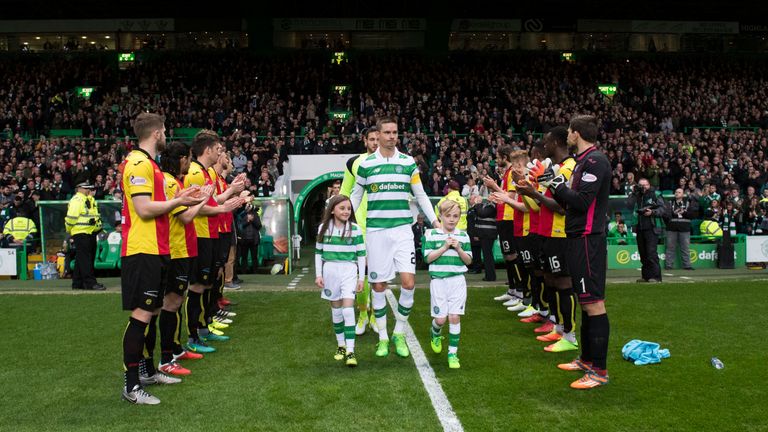 Partick Thistle players form a guard of honour for the Premiership champions Celtic
