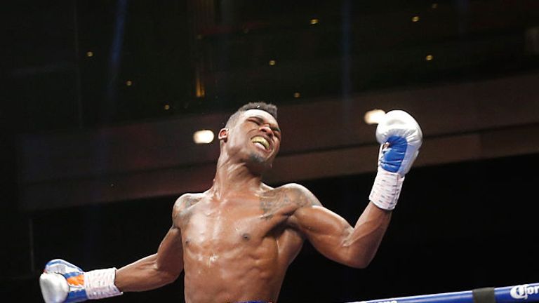 Super-welterweight boxer Jermell Charlo jumps in celebration after beating John Jackson to win the vacant WBC title.