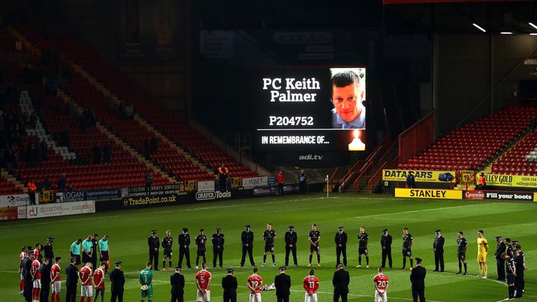  Players and policeman stand for a minute silence in tribute to PC Keith Palmer prior to the match between Charlton and MK Dons