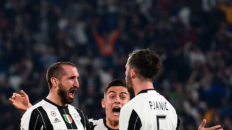 Juventus' defender from Italy Giorgio Chiellini (L) celebrates with teammates Juventus midfielder Miralem Pjanic and Juventus' forward from Argentina Paulo
