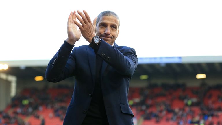Brighton & Hove Albion manager Chris Hughton applauds the traveling supporters after the Sky Bet Championship match at Oakwell, Barnsley.