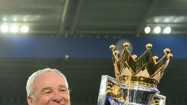 Claudio Ranieri poses for photographs with the Premier League Trophy as players and staffs celebrate the season champions 