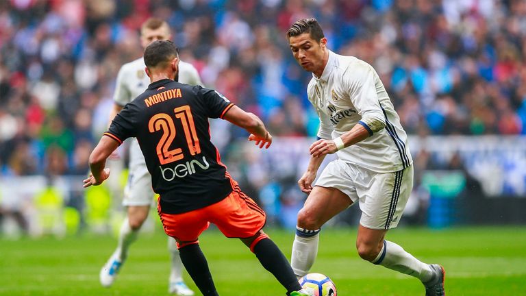 MADRID, SPAIN - APRIL 29: (L) Cristiano Ronaldo (R) of Real Madrid CF competes for the ball with Santi Mina of Valencia CF  during the La Liga match