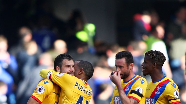 Luka Milivojevic and Jason Puncheon of Crystal Palace embrace after the Premier League win at Chelsea