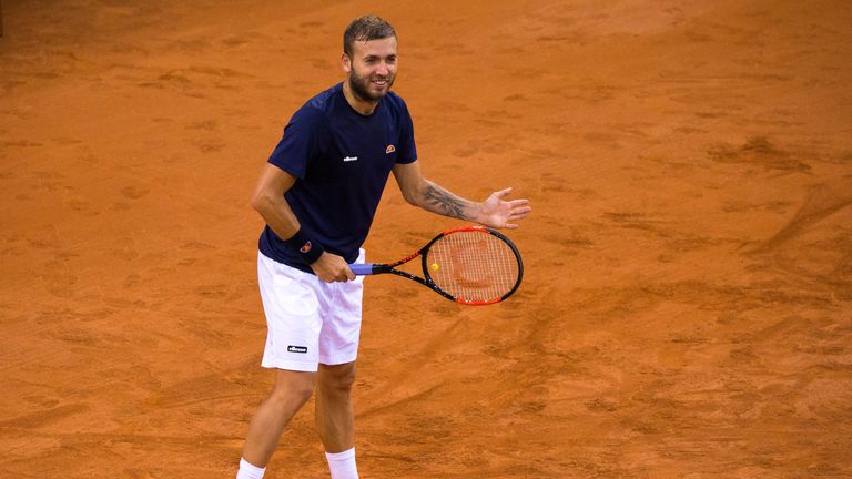 Dan Evans of Great Britain smiles in practice prior to the France v Great Britain Davis Cup World Group Quarter-Final