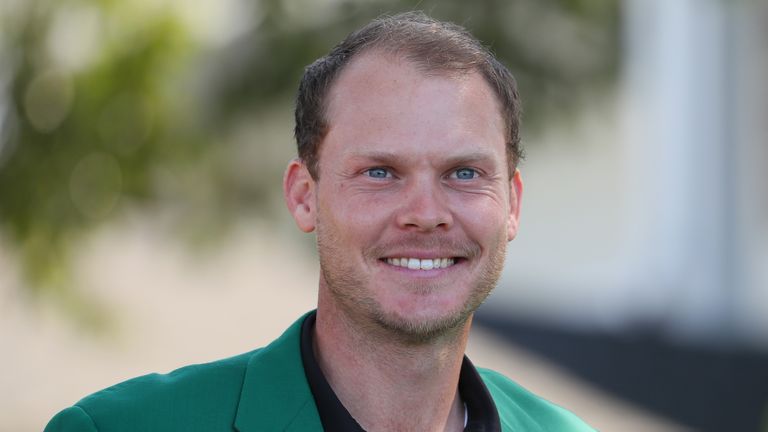 Danny Willett of England, the defending champion, is pictured wearing his green jacket during the Drive, Chip and Putt Championship