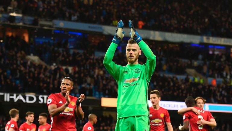 Manchester United's Spanish goalkeeper David de Gea (C) applauds their fans at the end of the English Premier League football match between Manchester City