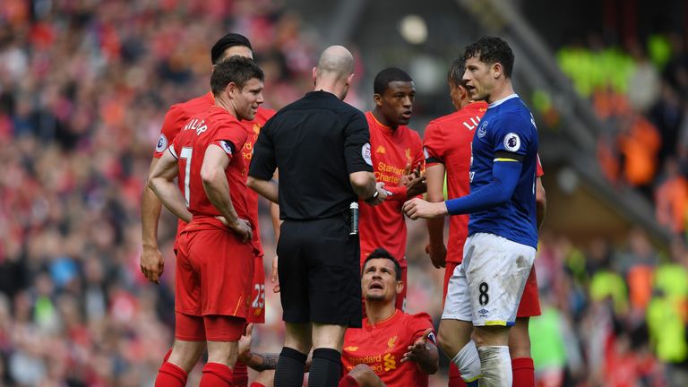 Dejan Lovren (grounded) and Ross Barkley of Everton speak to referee Anthony Taylor