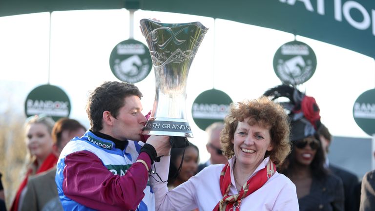 Jockey Derek Fox and trainer Lucinda Russell celebrate with the trophy after winning the Randox Health Grand National on One For Arthur on Grand National D