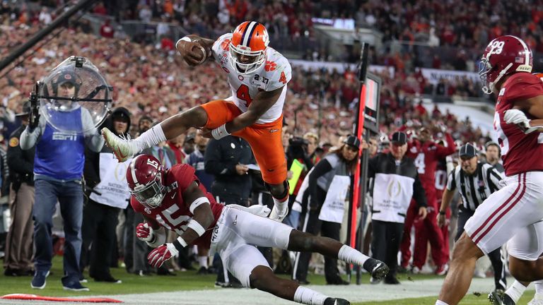 TAMPA, FL - JANUARY 09:  Quarterback Deshaun Watson #4 of the Clemson Tigers is stopped short of the goal line by defensive back Ronnie Harrison #15 of the