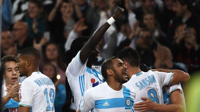 Olympique de Marseille's French midfielder Florian Thauvin celebrates with teammates after scoring a goal during the French L1 football match between Marse