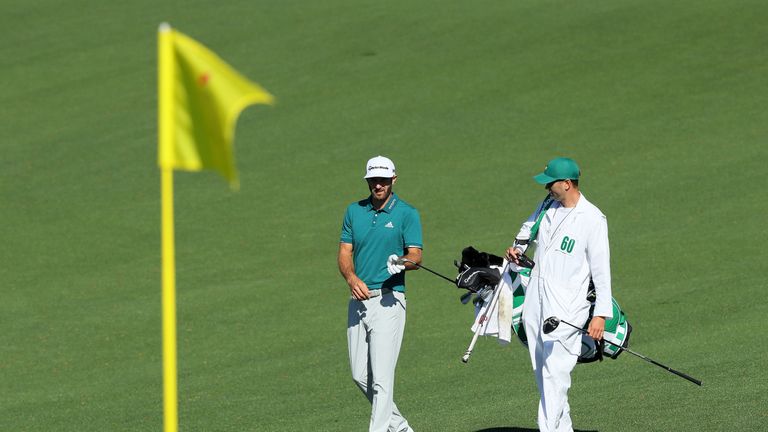 AUGUSTA, GA - APRIL 04:  Dustin Johnson of the United States and caddie Austin Johnson walk to the second green during a practice round prior to the start 