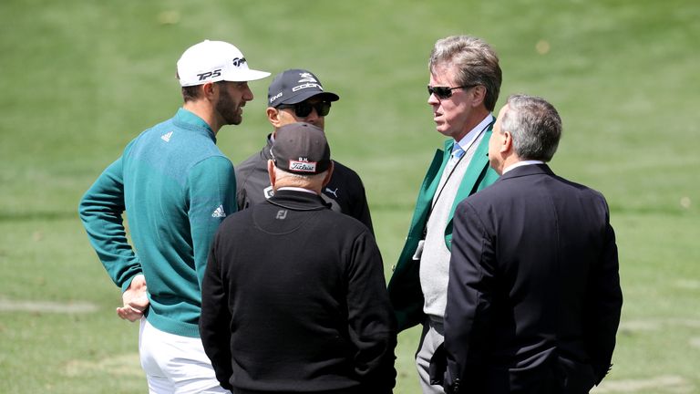 AUGUSTA, GA - APRIL 06:  Dustin Johnson (L) of the United States talks to Augusta National member Fred Ridley (2nd R) on the practice range prior to announ