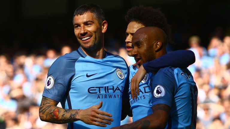 Manchester City's English midfielder Fabian Delph (R) celebrates scoring his team's third goal during the English Premier League football match between Man