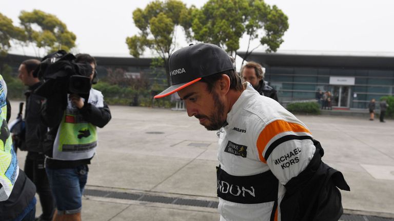 McLaren's Spanish driver Fernando Alonso walks to his pit garage during a practice session ahead of the Formula One Chinese Grand Prix in Shanghai on April