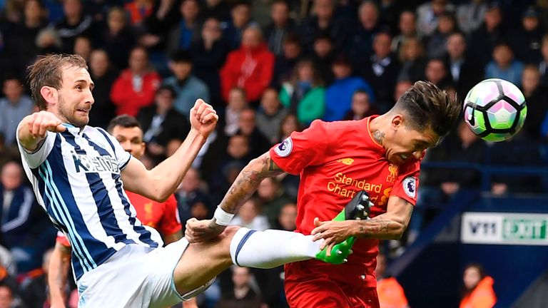 TOPSHOT - Liverpool's Brazilian midfielder Roberto Firmino (R) heads the opening goal past West Bromwich Albion's English defender Craig Dawson during the 