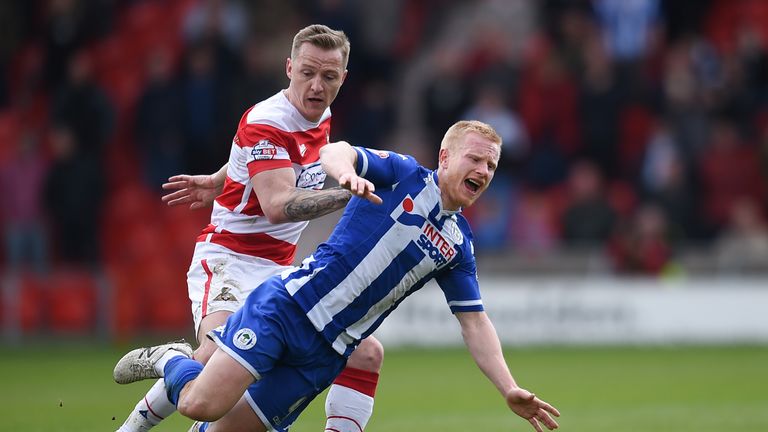Doncaster's Gary McSheffrey challenges Wigan's David Perkins during the Sky Bet League One match at the Keepmoat Stadium, Doncaster.