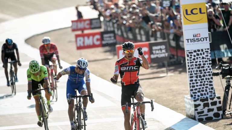 Belgium's Greg Van Avermaet (R) celebrates as he crosses the finish line ahead of Czech Republic's Zdenek Stybar (2ndR) at the end of the 115th edition of 