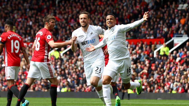 MANCHESTER, ENGLAND - APRIL 30:  Gylfi Sigurdsson of Swansea City celebrates scoring his sides first goal with Martin Olsson of Swansea City during the Pre