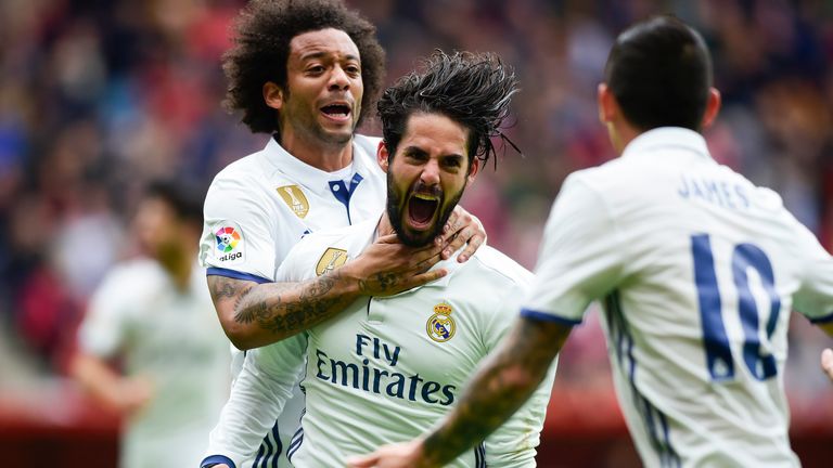 Isco celebrates his late winner with team-mate Marcelo 