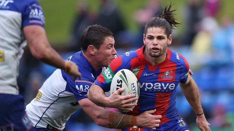 NEWCASTLE, AUSTRALIA - AUGUST 06: Jake Mamo of the Knights is tackled during the round 22 NRL match between the Newcastle Knights and the Canterbury Bulldo