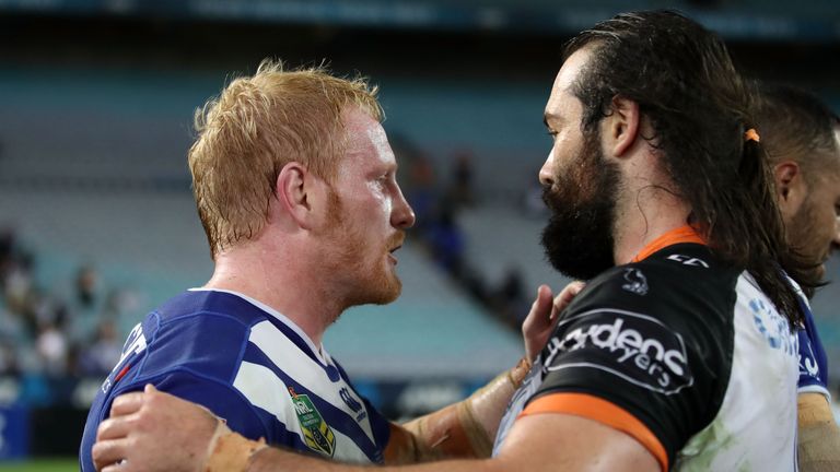 SYDNEY, AUSTRALIA - APRIL 23: James Graham of the Bulldogs and Aaron Woods of the Tigers shakes hands after the round eight NRL match between the Wests Tig