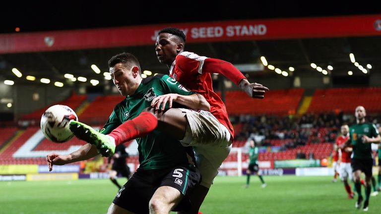 LONDON, ENGLAND - MARCH 07:  Joe Aribo of Charlton Athletic battles with Murray Wallace of Scunthorpe United during the Sky Bet League One match between Ch