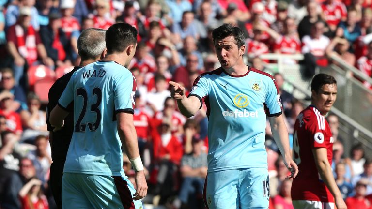 MIDDLESBROUGH, ENGLAND - APRIL 08: Joey Barton of Burnley (R) argues with referee Martin Atkinson during the Premier League match between Middlesbrough and