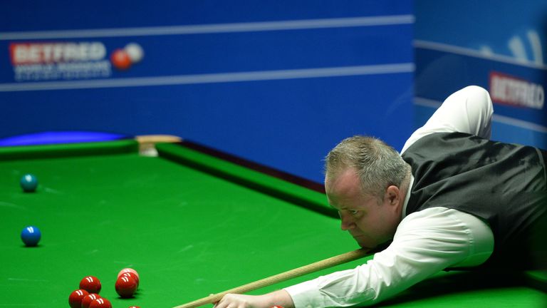 John Higgins at the table in his match against Martin Gould on day four of the Betfred Snooker World Championships at the Crucible Theatre, Sheffield.