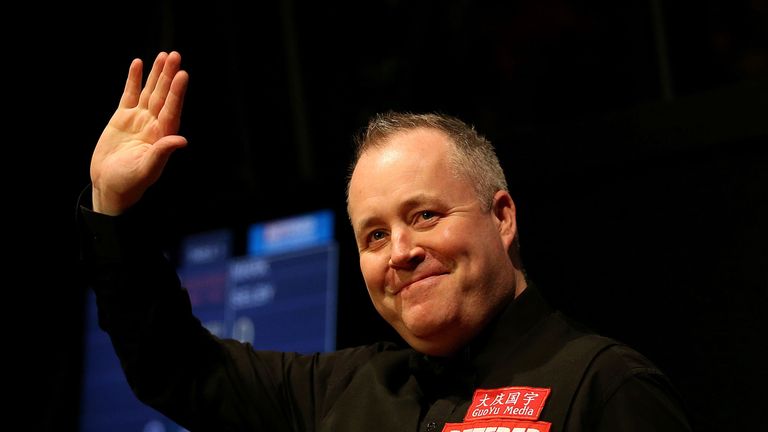 John Higgins during the walk on at the start of the final on day sixteen