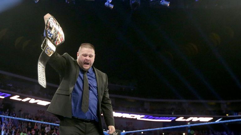 Kevin Owens, U.S. Championship in hand, stands over a beaten AJ Styles.