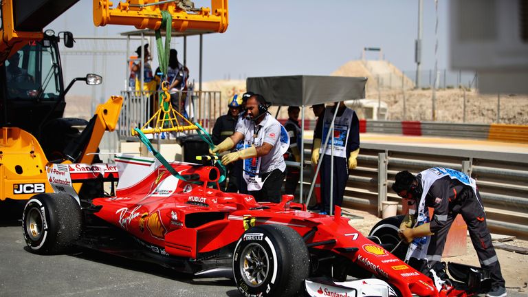 BAHRAIN, BAHRAIN - APRIL 14: The car of Kimi Raikkonen of Finland and Ferrari is hooked up to a trackside removal vehicle after breaking down during practi