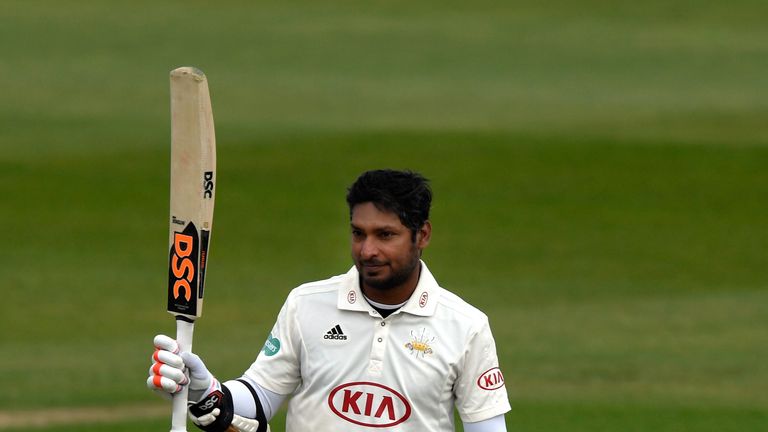 Surrey batsman Kumar Sangakkara raises his bat after reaching his century against Warwickshire in the County Championship