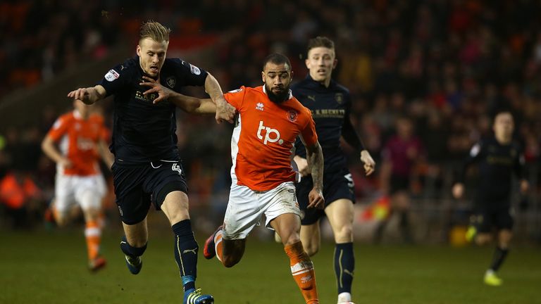 BLACKPOOL, ENGLAND - JANUARY 07:  Kyle Vassell of Blackpool controls the ball under pressure from Marc Roberts and Angus MacDonald of Barnsley during The E
