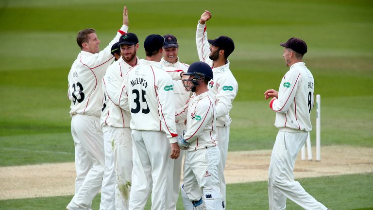 LONDON, ENGLAND - APRIL 16:  Alex Davies and Saqib Mahmood celebrate with their teammates after running out Alex Davies of Surrey during day three of the S