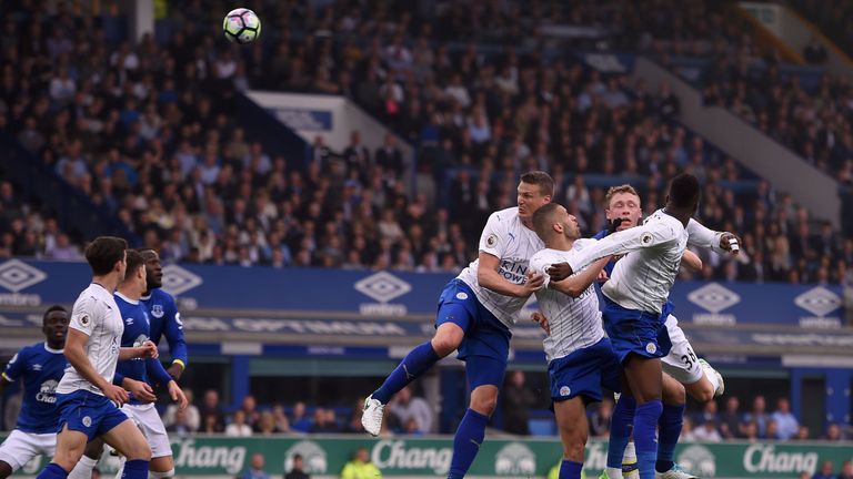 Leicester City's Robert Huth (C) heads clear against Everton