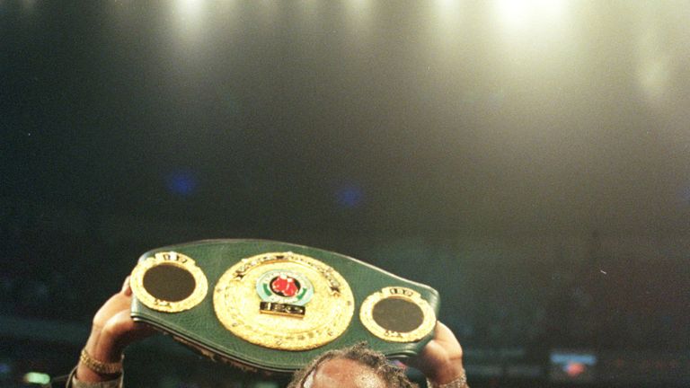 Lennox Lewis displays his championsip belts after defeatin Evamder Holyfield in  the World Heavyweight Championship unification fight.