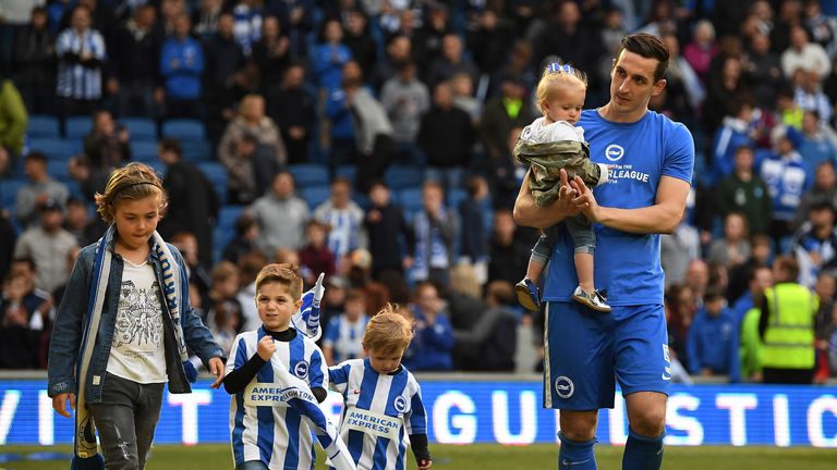 Lewis walks around the pitch with children during Brighton's lap of honour