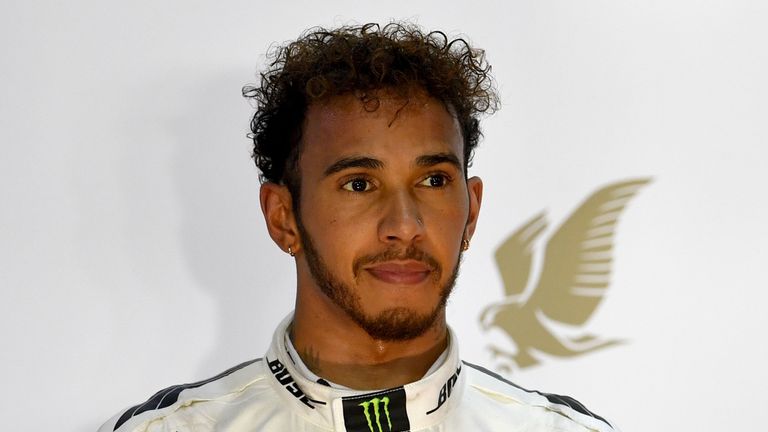 Mercedes' British driver Lewis Hamilton stands on the podium after taking the second place at the end of the Bahrain Formula One Grand Prix