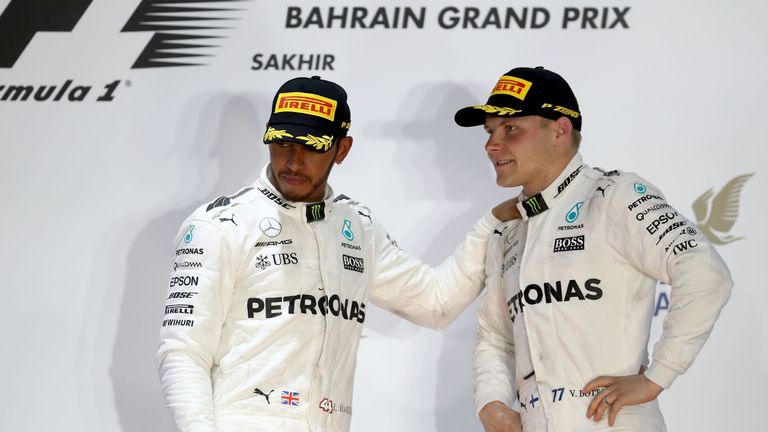 BAHRAIN, BAHRAIN - APRIL 16: Second and third placed drivers Lewis Hamilton of Great Britain and Mercedes GP and Valtteri Bottas of Finland and Mercedes GP