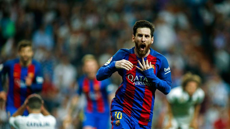 Barcelona's Argentinian forward Lionel Messi celebrates after scoring during the Spanish league Clasico football match Real Madrid CF vs FC Barcelona at th