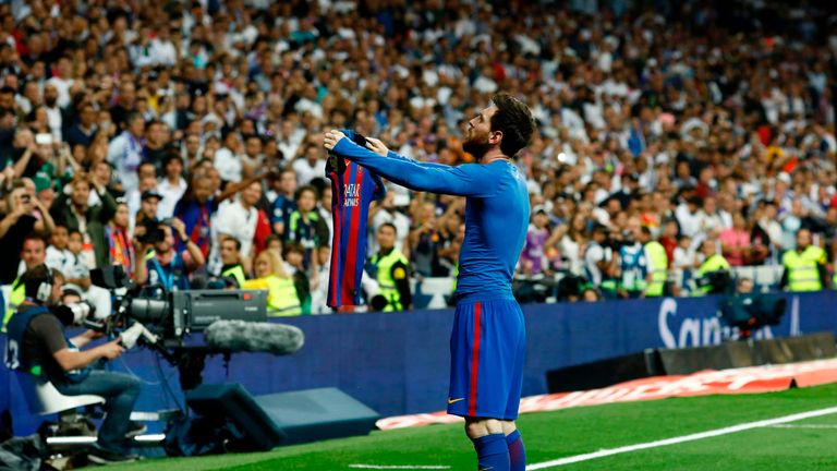 Barcelona's Argentinian forward Lionel Messi celebrates after scoring during the Spanish league Clasico football match Real Madrid CF vs FC Barcelona at th