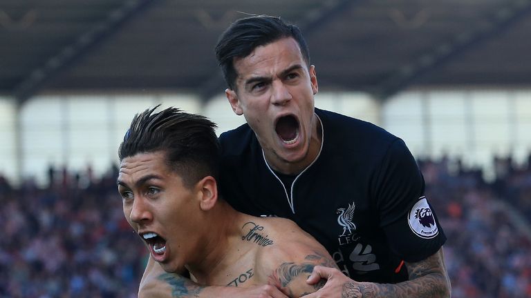 Liverpool's Brazilian midfielder Roberto Firmino (L) celebrates scoring his team's second goal with Liverpool's Brazilian midfielder Philippe Coutinho duri