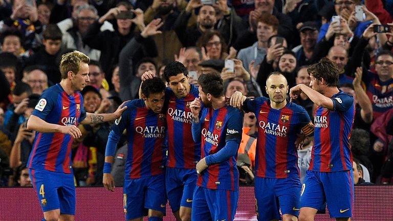 Luis Suarez (3L) celebrates scoring Barcelona's first goal with team-mates during the La Liga match with Sevilla