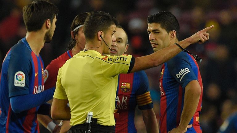 The referee shows the red card to Barcelona's Uruguayan forward Luis Suarez (R) during the Spanish Copa del Rey (King's Cup) semi final