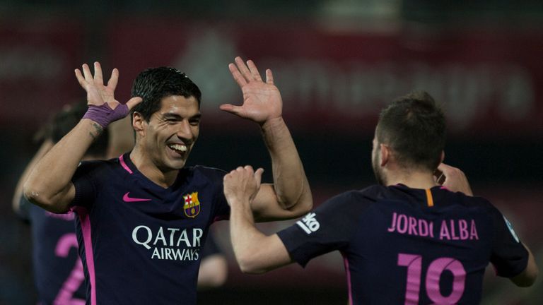 Luis Suarez (L) celebrates with Jordi Alba after scoring during the Spanish league football match between Granada and Barcelona